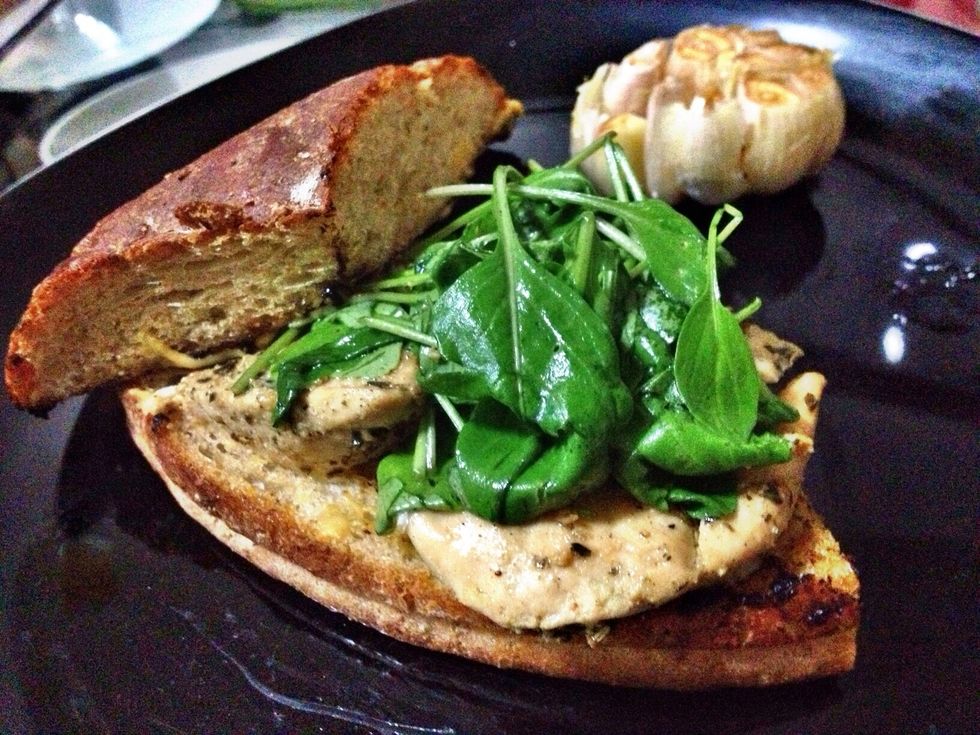 Spread on some good European Mustard on the bottom, slice your chicken horizontal, put zesty greens on top. Serve w roasted garlic on the side YUM!!!