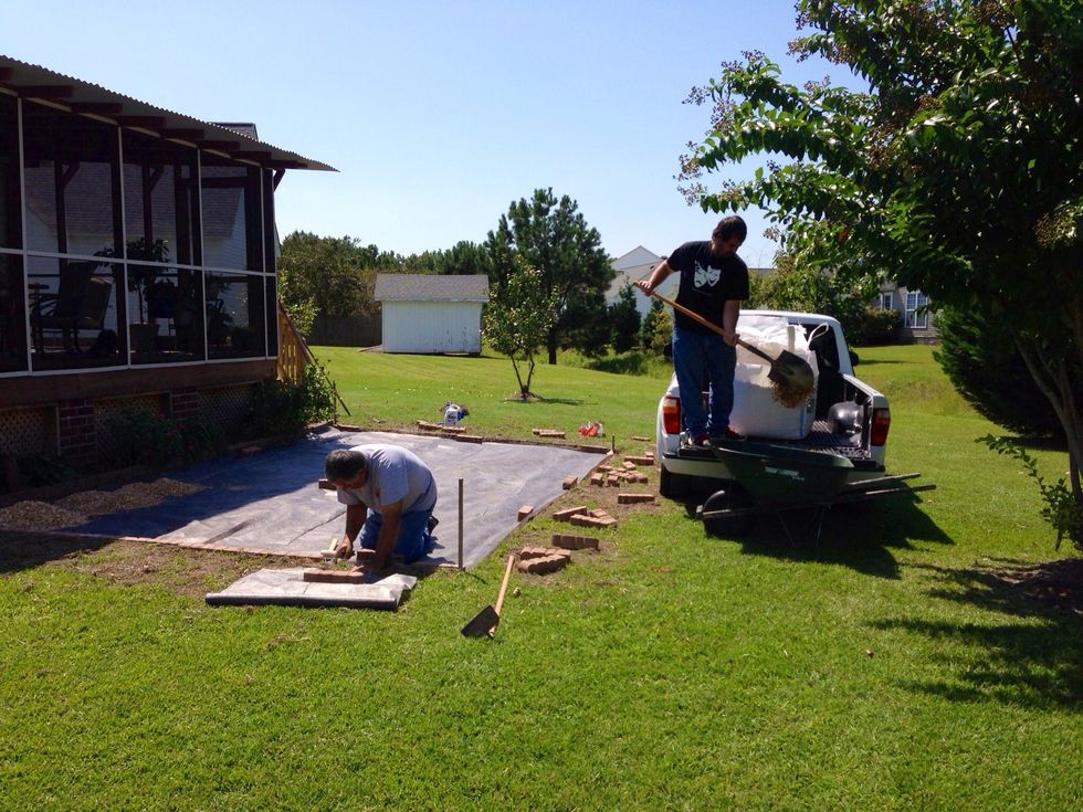Spread out garden cloth, and set border in place over the edges of the garden cloth. Use mallet to adjust placement as needed.