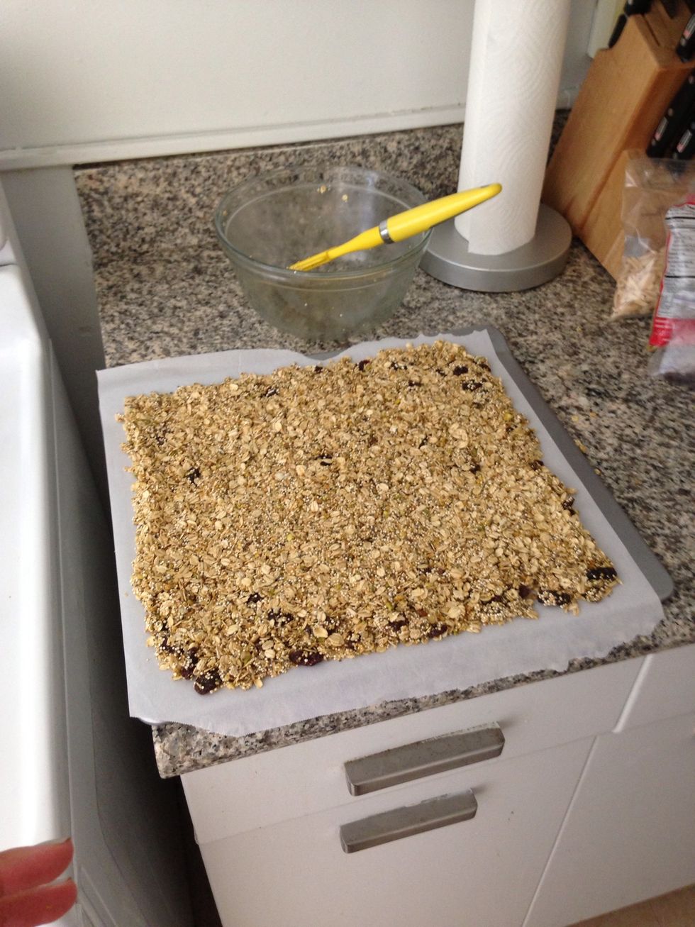 Spread out granola so it's one even later. I recommend using a rubber spatula to minimize stickiness.