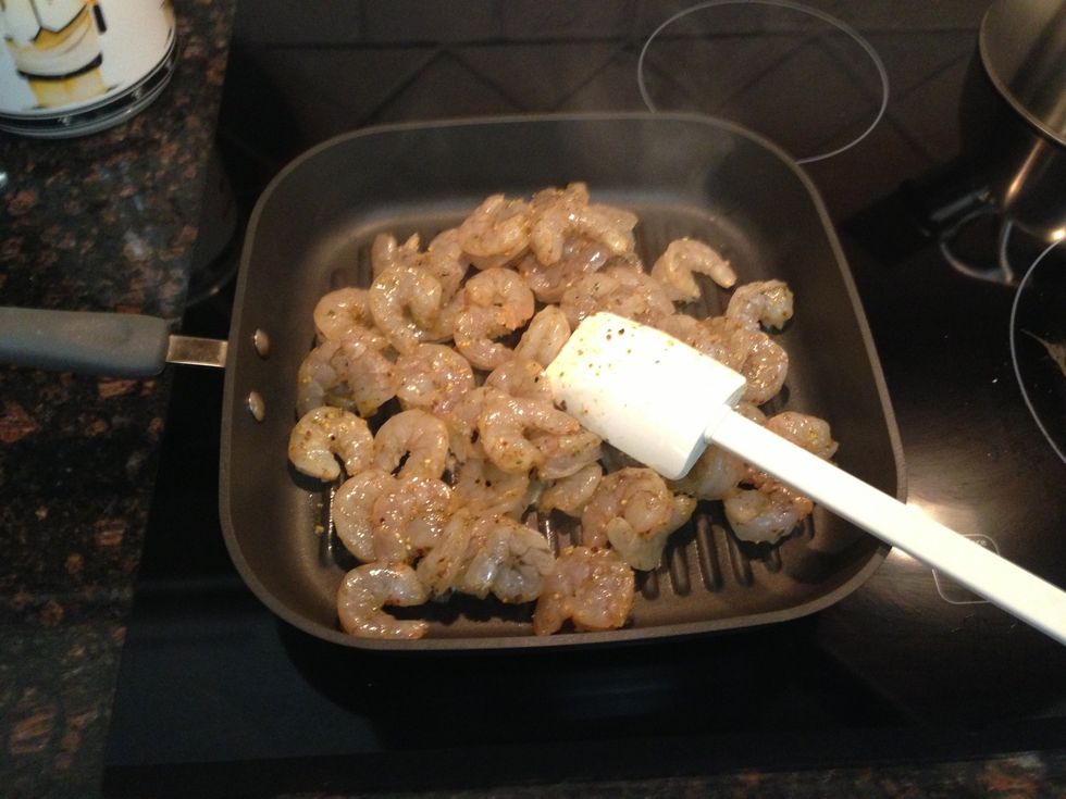 Spread out shrimp in pan using mix n scrap spatula.