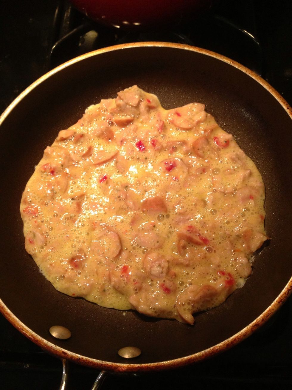 Spread out your batter on the heated pan distributing the sausage evenly across