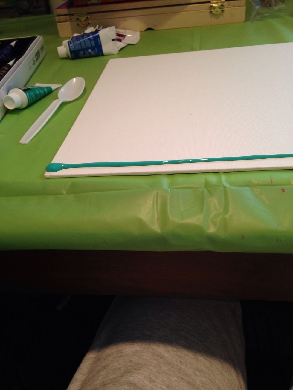 Spread out your first color on the top of the canvas