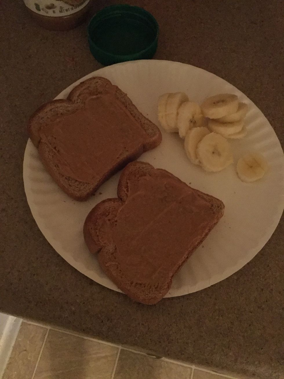 Spread peanut butter on toast to liking