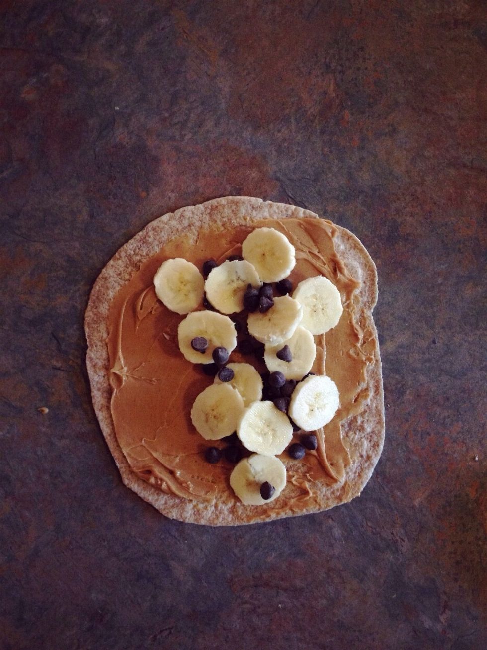 Spread peanut butter on whole wheat tortilla, add chocolate chips and sliced banana