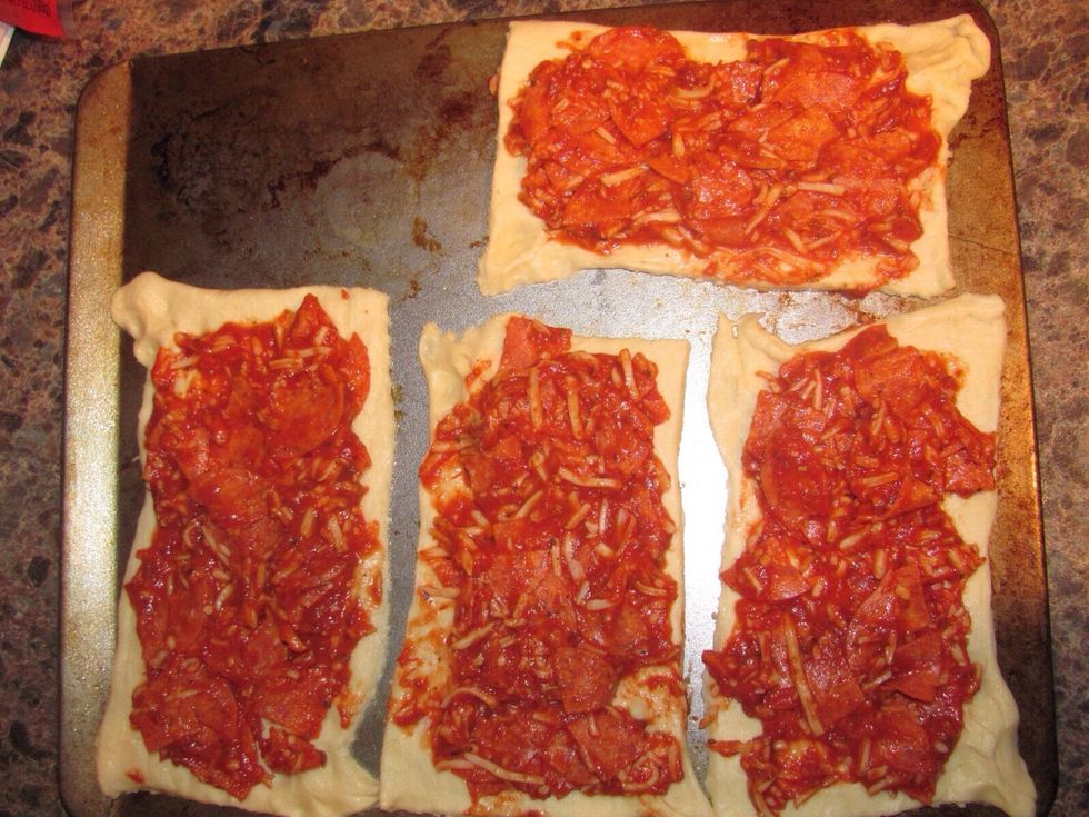 Spread pizza mixture evenly on to rectangles, leaving space on the longer sides