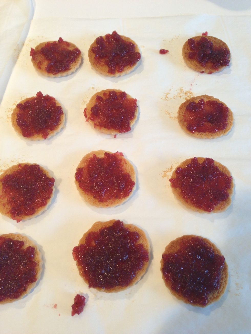 Spread raspberry jelly on the bottoms of all the cookies.