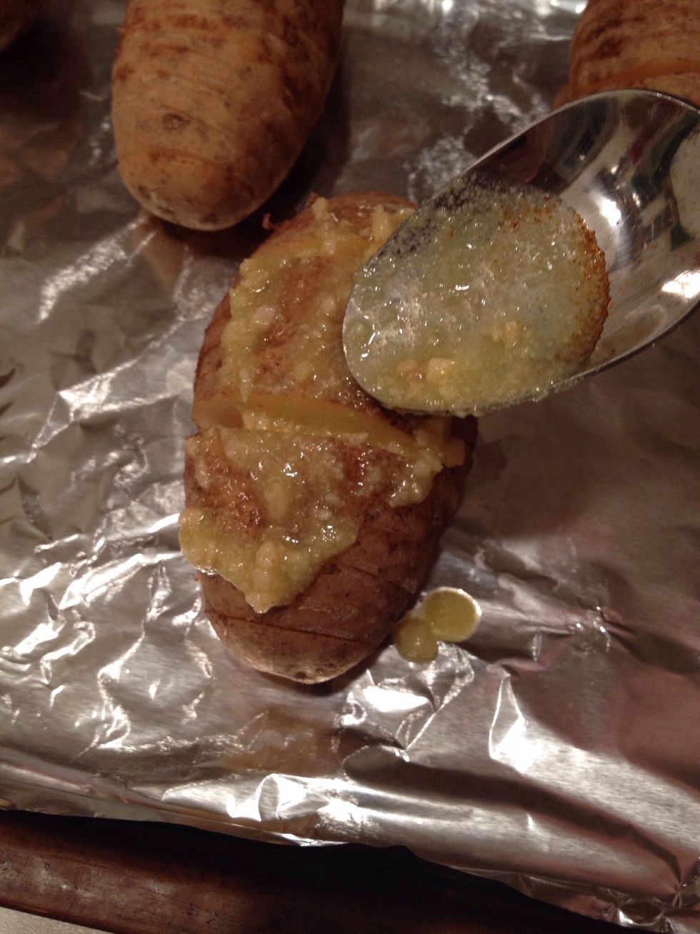 Spread sauce on top of potatoes. Try to scoop some of the sauce in each slice.