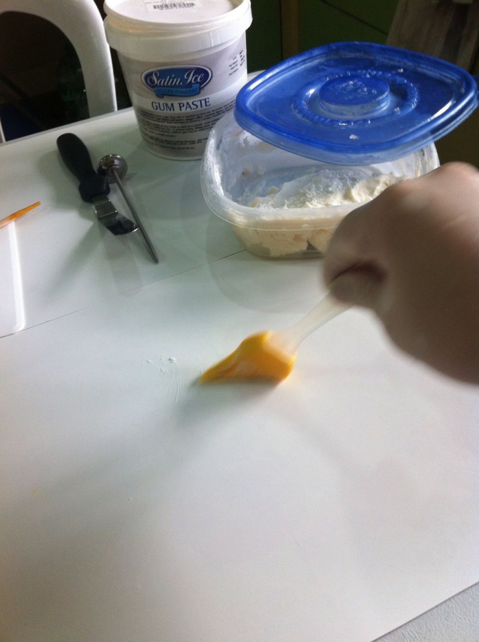 Spread shortening into the mat. But not too much bec. it will make the gum paste to soft and and sticky.:)