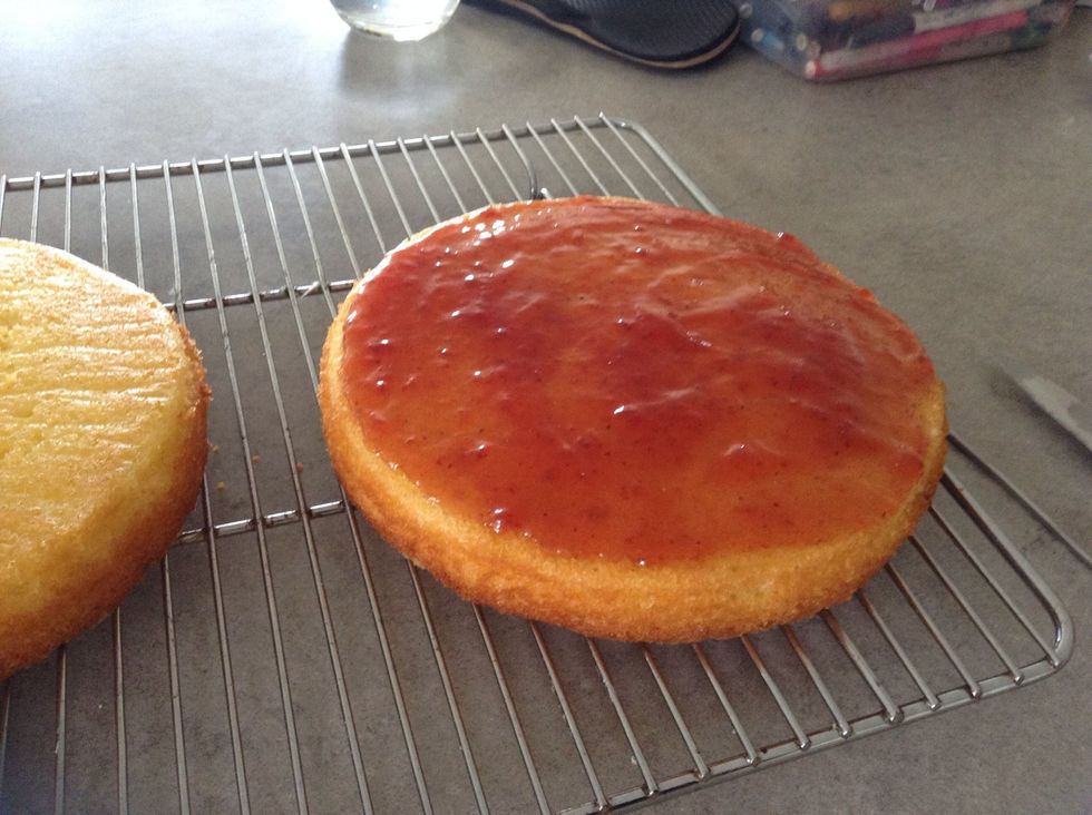 Spread strawberry jam onto one side
