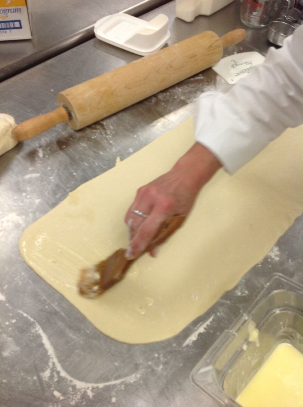 Spread surface of dough with melted butter