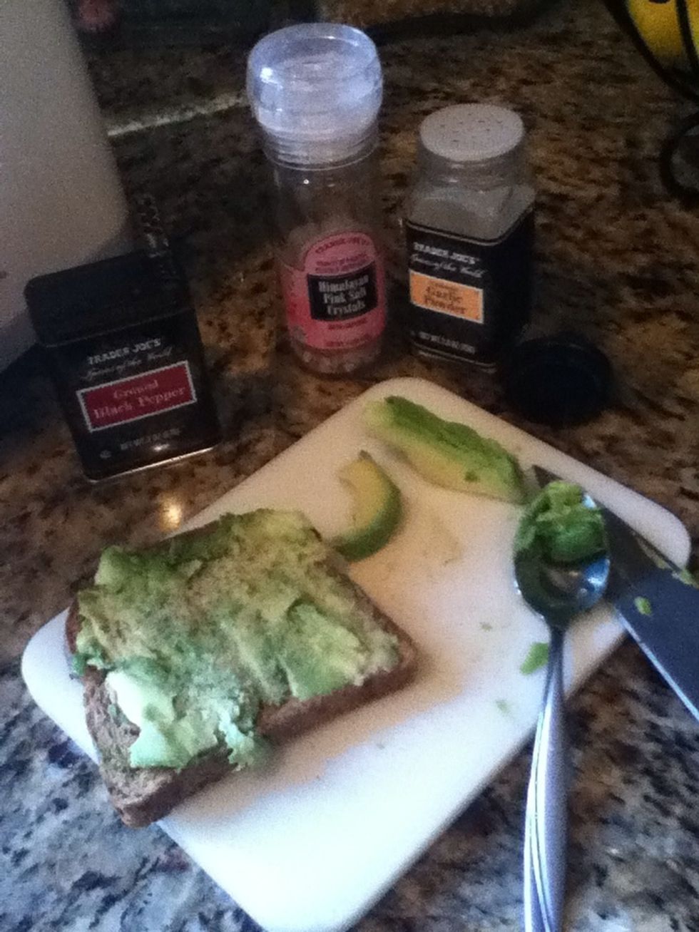 Spread that glorious avocado on your freshly toasted piece of bread. Sprinkle with salt pepper and garlic powder