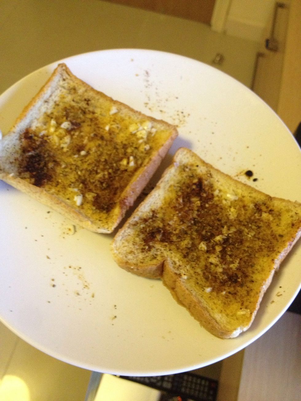 Spread the butter add a little bit of minced garlic (1clove) sprinkle some oregano and paprika and put back in the microwave for a minute. Sit to cool. They'll get crunchy.