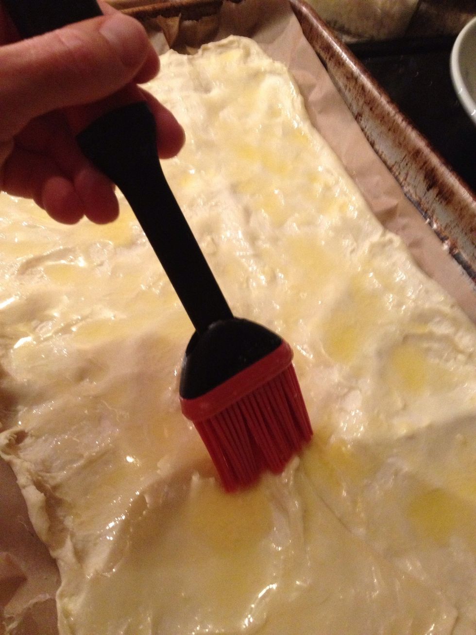 Spread the butter all over the pastry sheet.