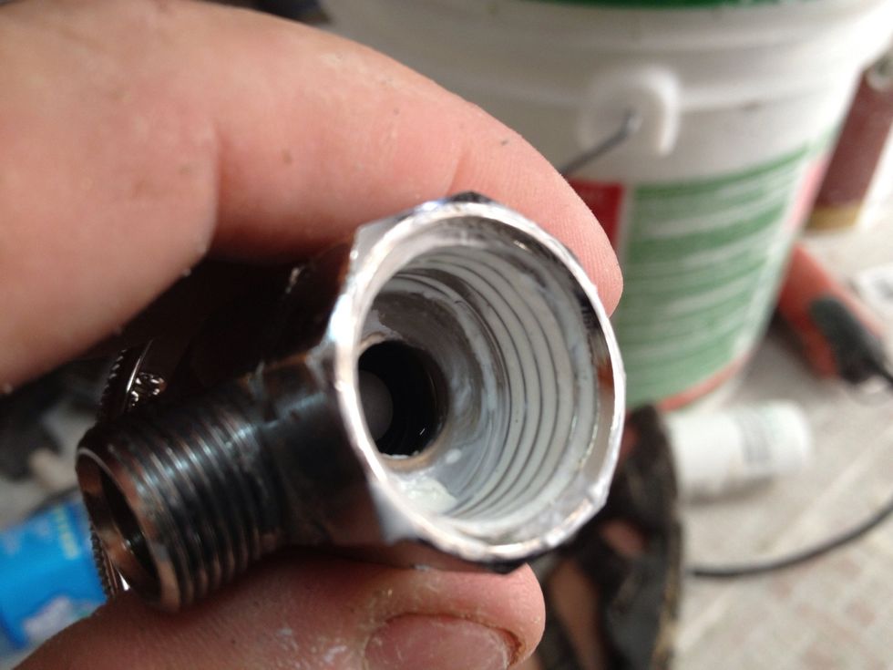 Spread the caulk across the threads with your finger. Clean up any excess caulk so it doesn't clog the hole when you screw it onto the pipe.
