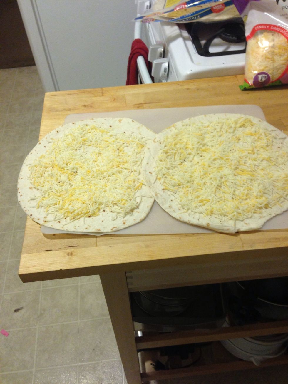 Spread the cheese evenly across the quesadilla. The chicken should be finished now.