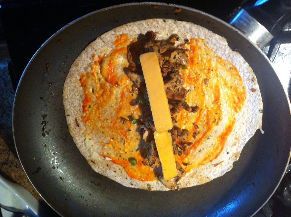 Spread the chicken grilled earlier, and then cover with some sliced cheddar cheese.