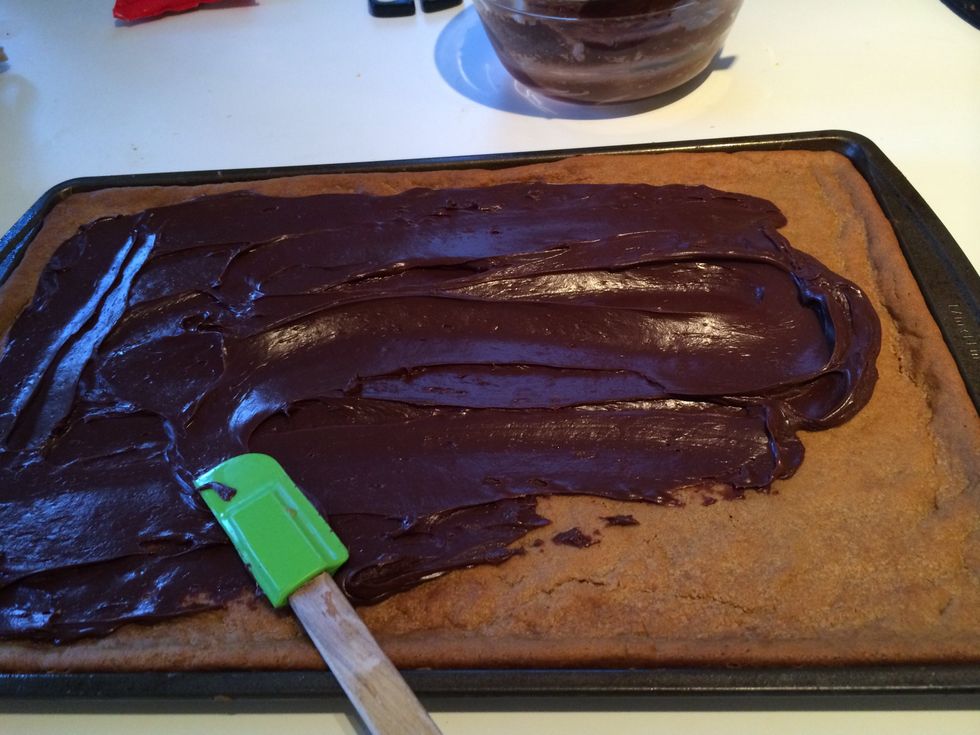 Spread the chocolate fudge with the spatula on to the cookie.  Try to make the chocolate as even as possible.  Work quickly, because it will begin to "set" almost immediately!