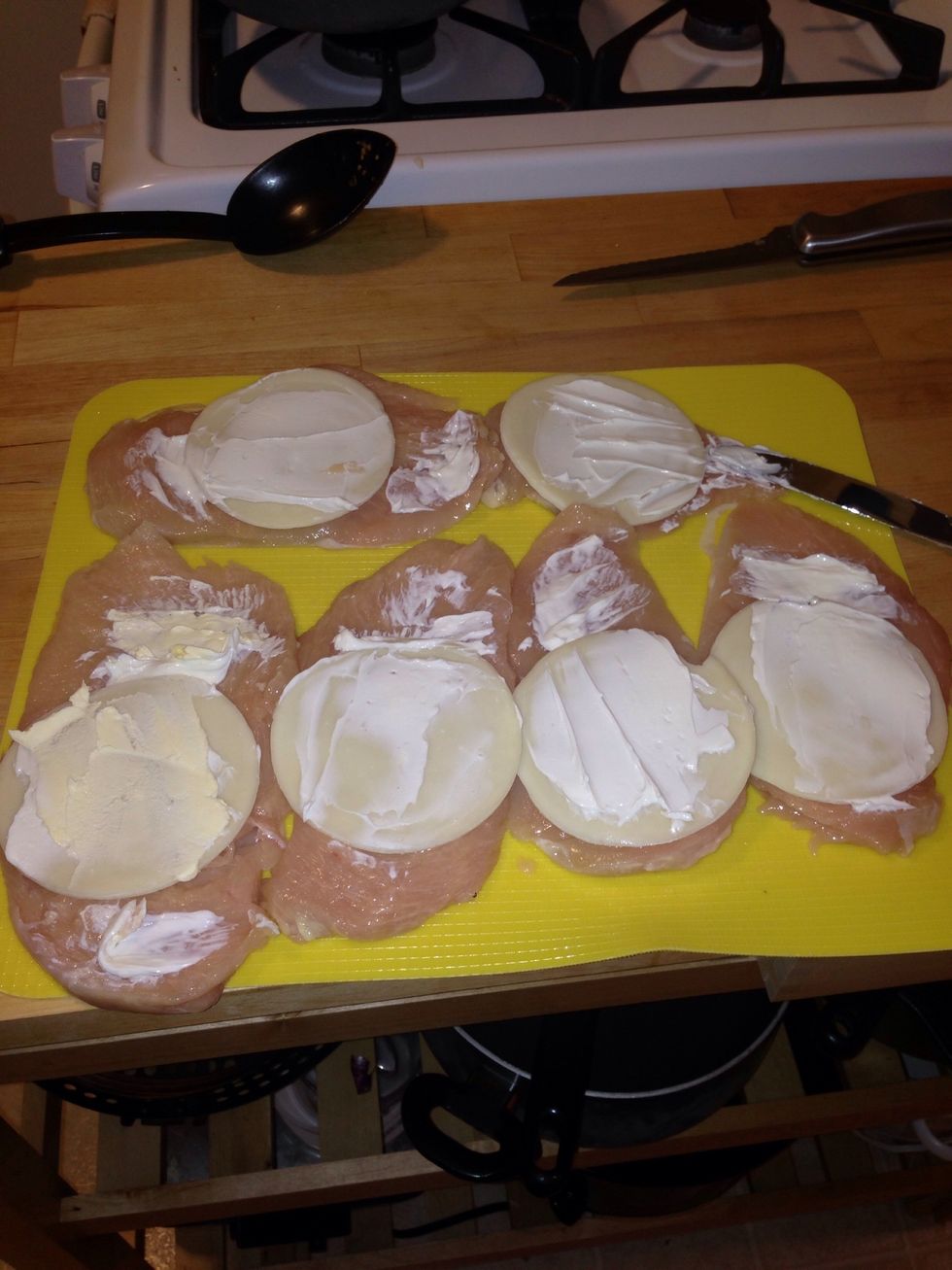 Spread the cream cheese on the chicken breast. Make sure you don't use the same utensil on the chicken as you do in the cream cheese or butter.