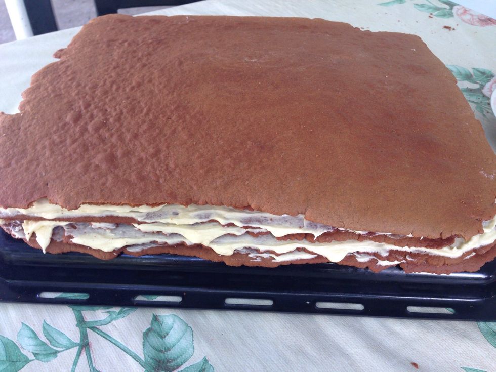 Spread the cream on each layer, but leave the last layer as it is