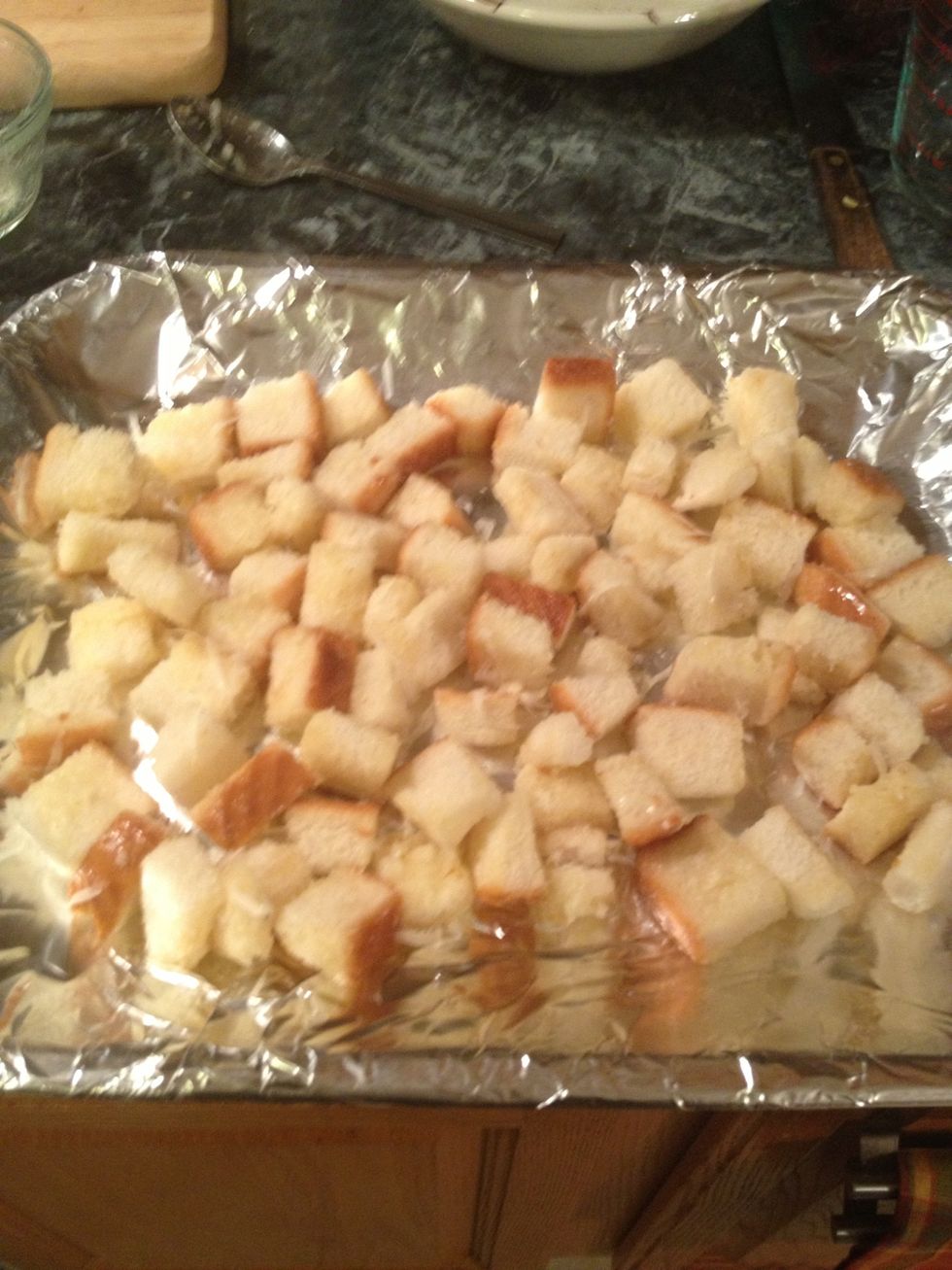 Spread the croutons on a baking sheet and bake in a 375 degree oven or toaster oven for 6-7 minutes, just until croutons are nice and brown.