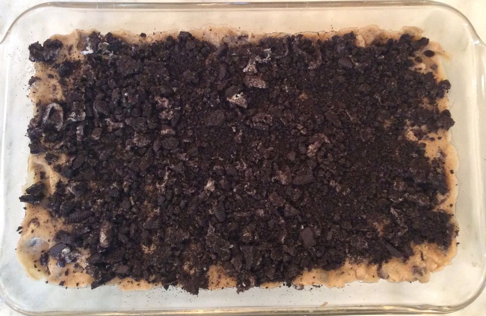 Spread the crushed Oreos evenly over the cookie dough