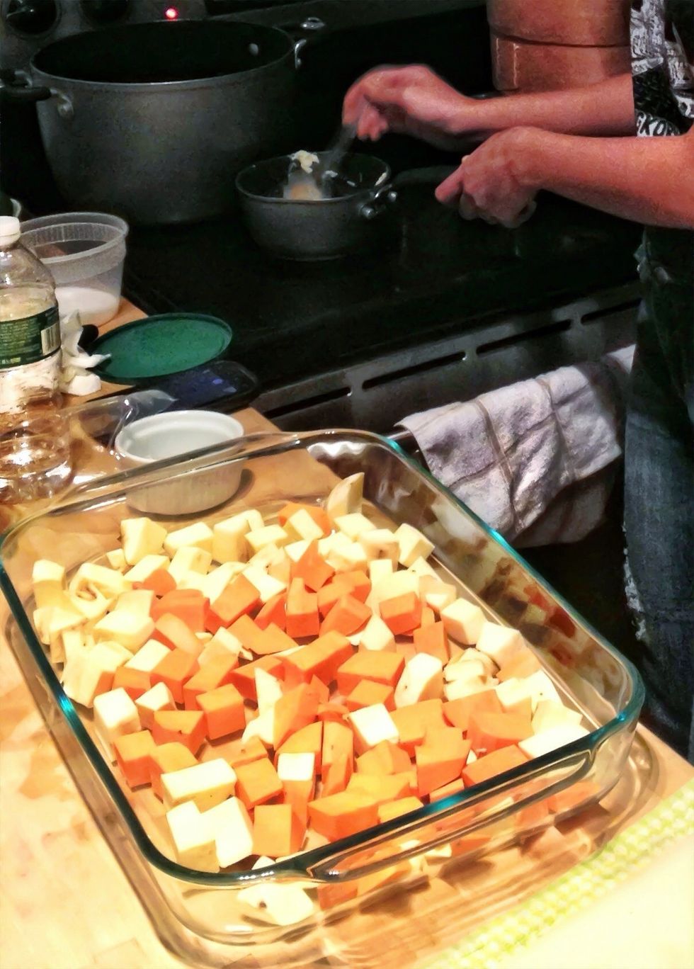 Spread the diced potatoes evenly across a large baking dish. Melt the butter in a small pot over medium heat. Add the palm sugar and stir until well blended.