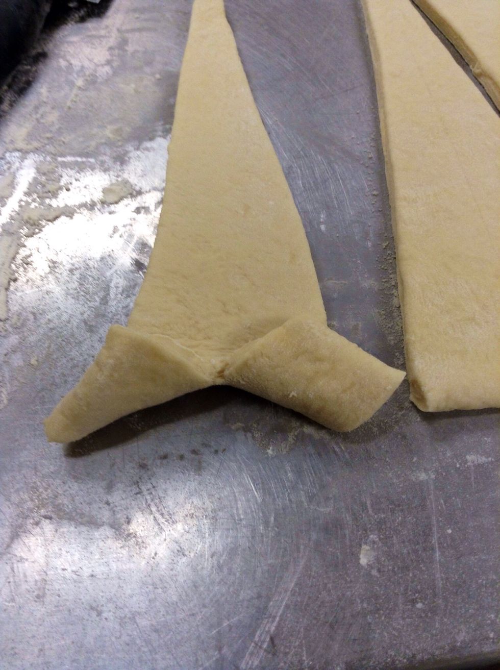 Spread the flaps outwards as shown. And roll up, keeping it pretty tight. You can also add some cheese and ham or what have you in this step.