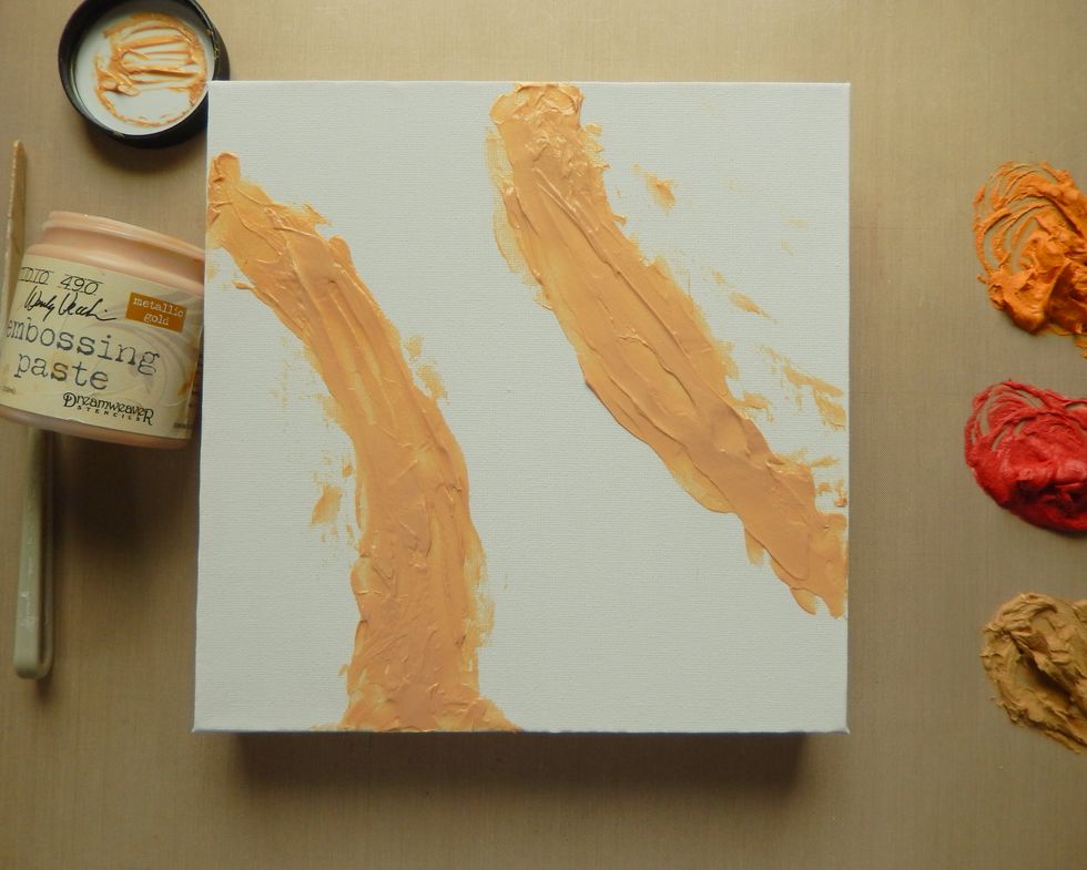 Spread the Gold Embossing Paste across an 8x8 inch canvas to create a 'channel'.