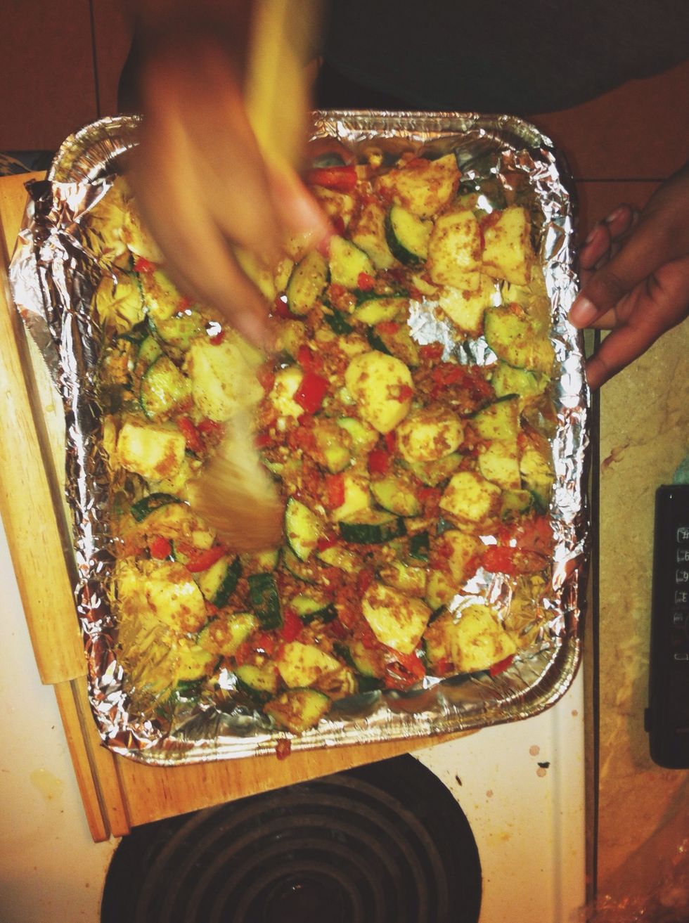 Spread the ingredients to cover all areas in the pan