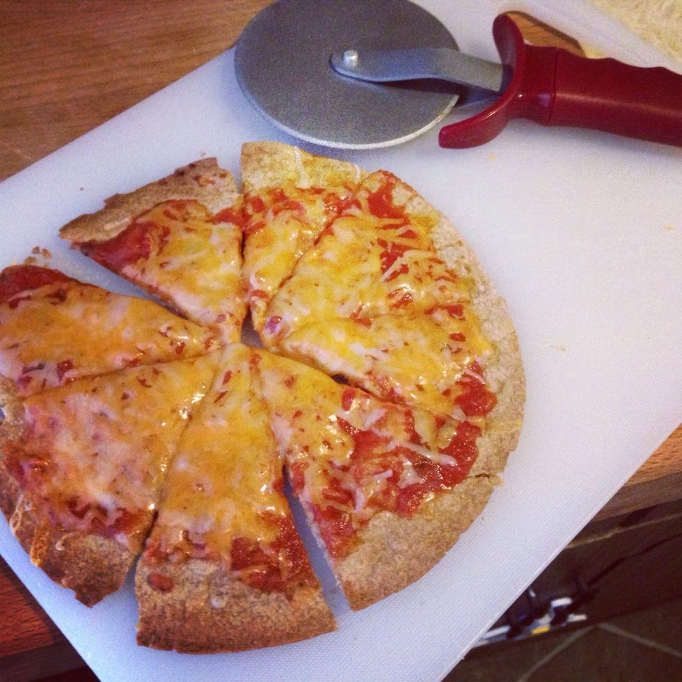Spread the marinara over the toasted tortilla, and sprinkle cheese on top. Top with the rest of your toppings and return the pizza to the toaster until the cheese has melted. Slice and enjoy!