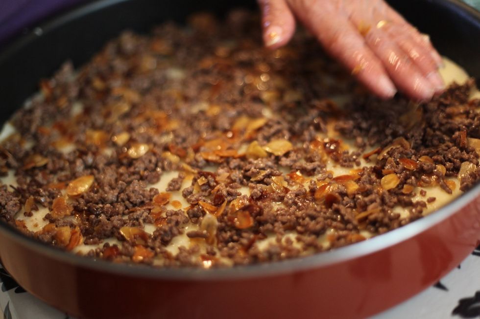 Spread the mince and almond all around making sure you cover the potato like so.