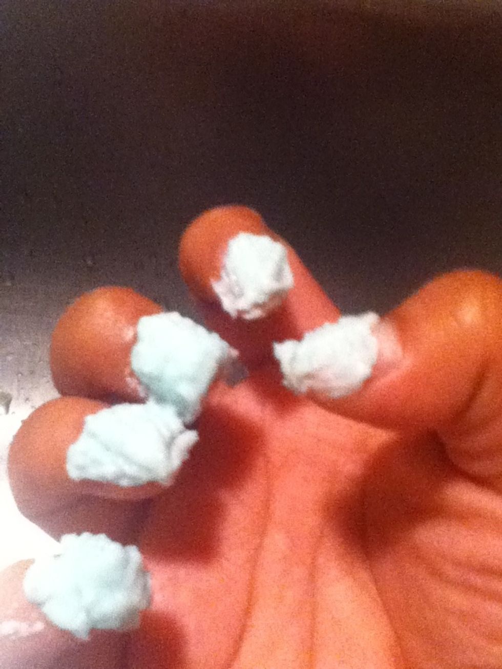 Spread the mix of toothpaste and baking soda over the top and bottom of your nails