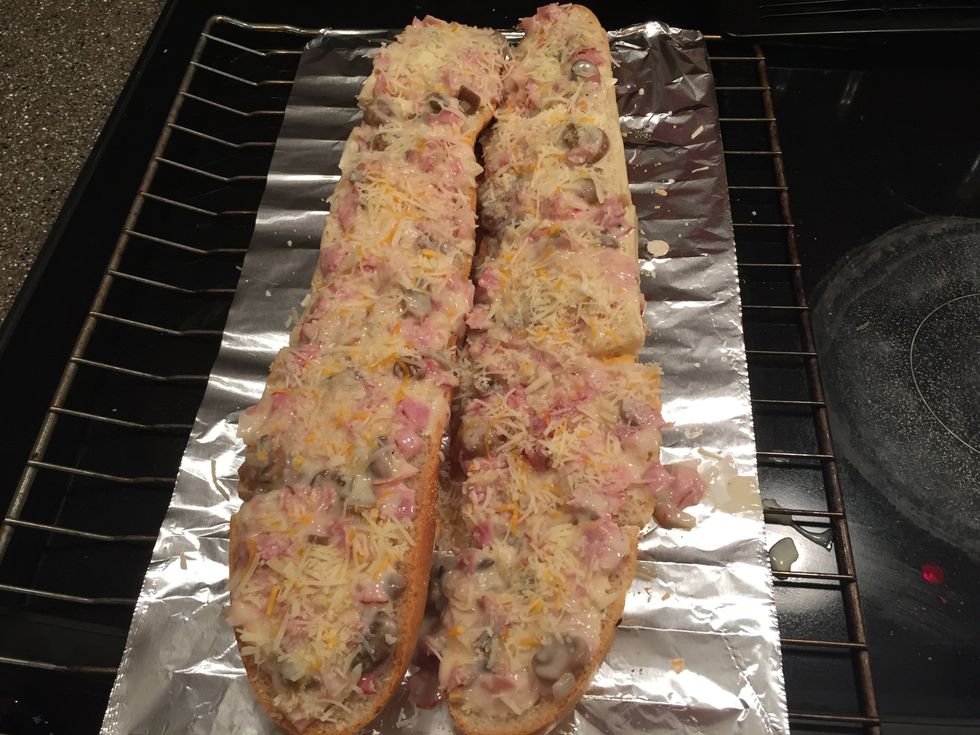 Spread the mixture evenly on the bread using a spoon and sprinkle the cheese on.