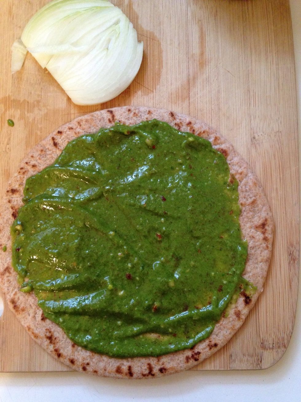 Spread the mixture on a whole wheat flatbread or wrap. Add onions and mozzarella. Bake at 300 degrees F for 10 minutes, or until lightly browned and crispy.