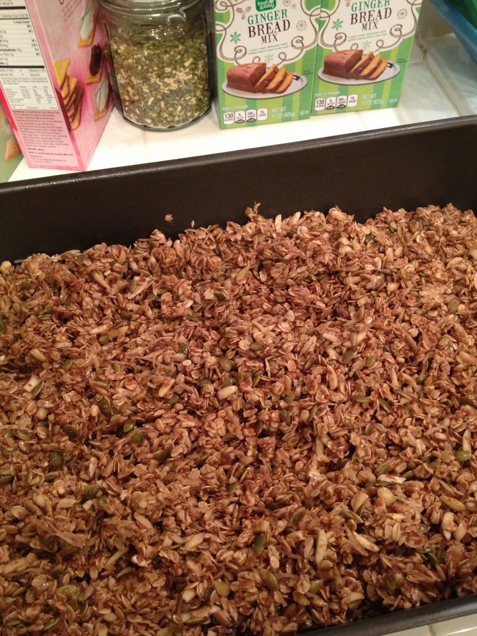 Spread the mixture out into a large roasting pan. Put it into a pre-heated oven (325 degrees F). At each 15 or 20 minute interval, use a spatula to stir and turn the granola, so that it bakes evenly.
