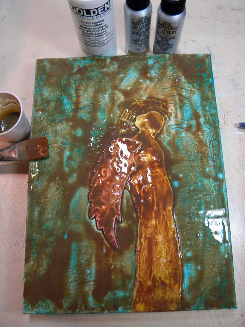 Spread the mixture thickly all over the canvas and let it sit for about 10 minutes. The glaze will seep into all the nooks and crannies and really let those cracks show.