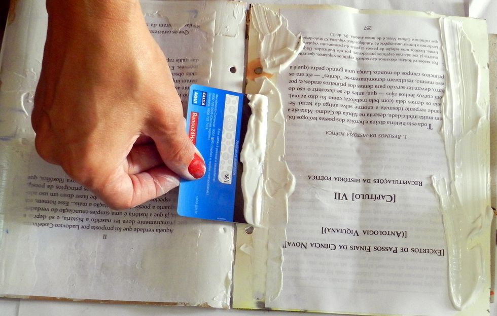 Spread the modeling paste with the help of an old credit card.