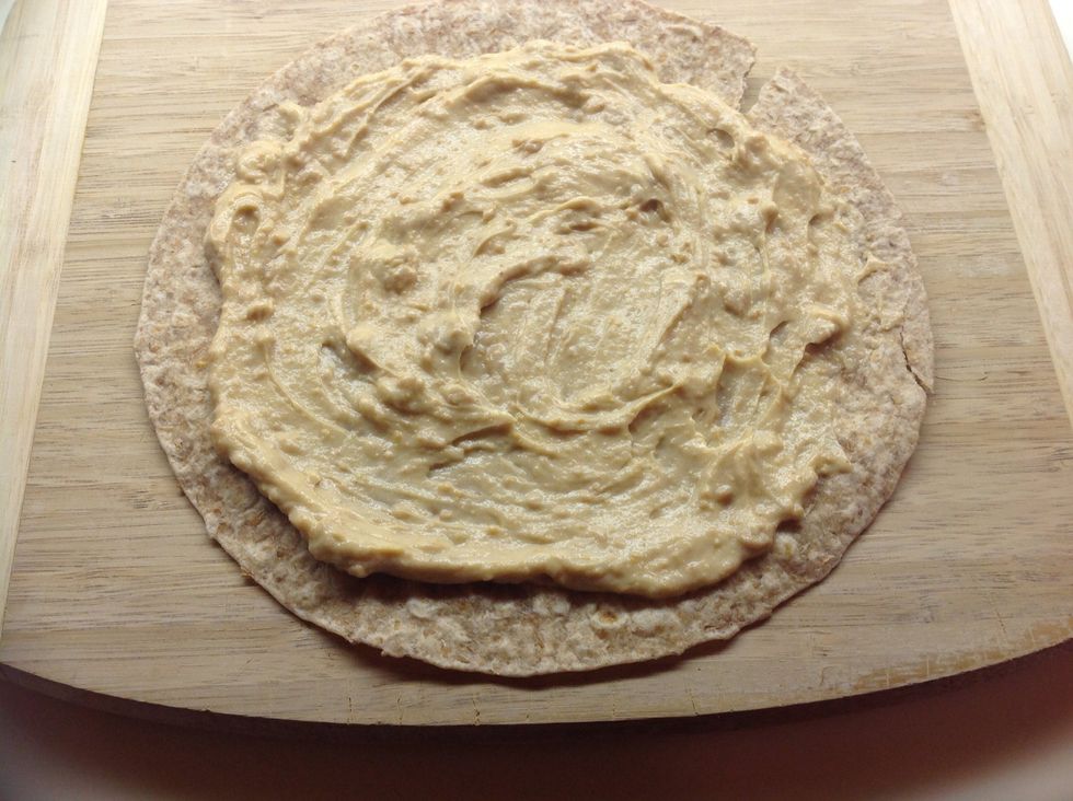 Spread the peanut butter mixture onto the tortilla. Be sure to leave some room around the edge - it will probably squish out later if you don't!