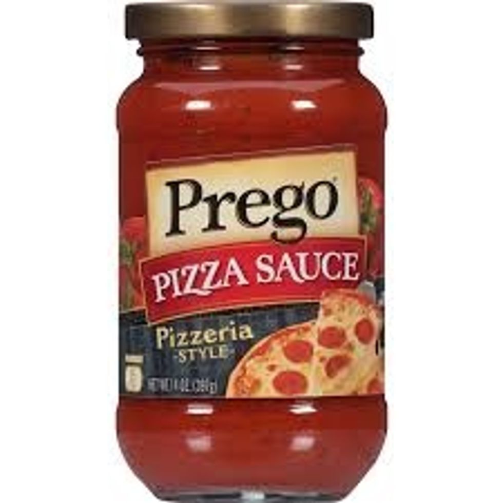 spread the pizza sauce onto the spread out  pizza dough
