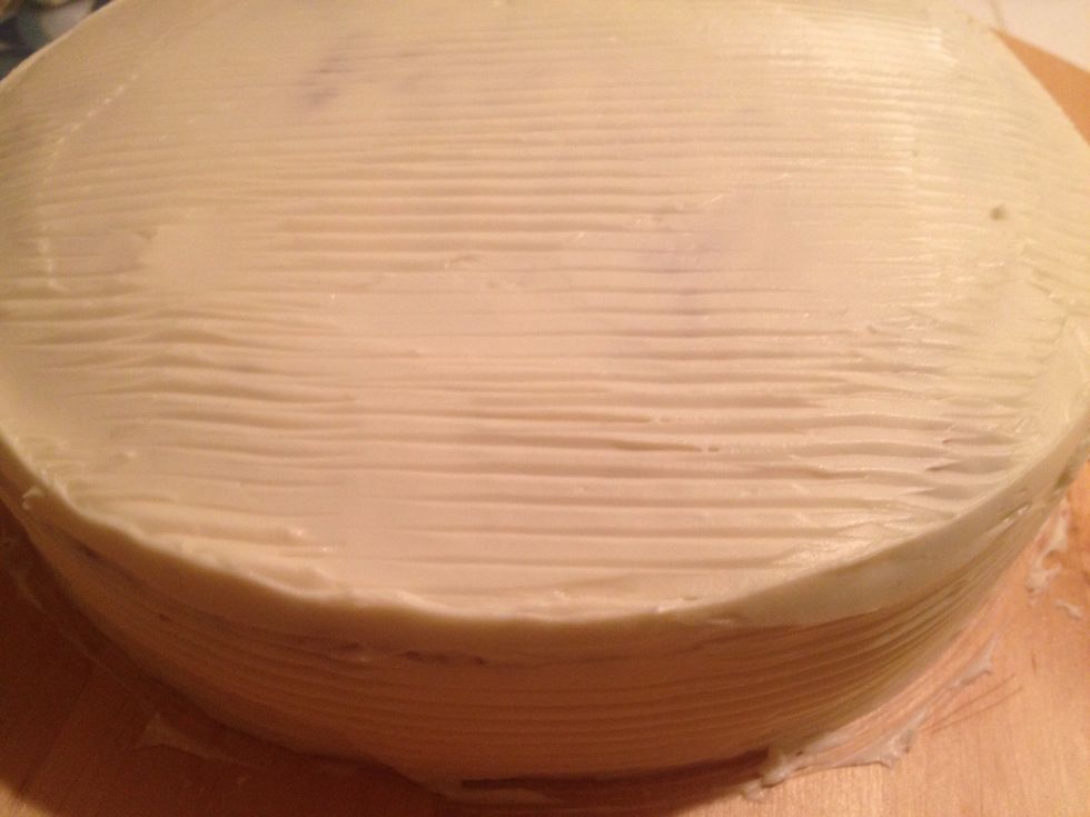 Spread the remaining cream cheese frosting on the cake evenly.