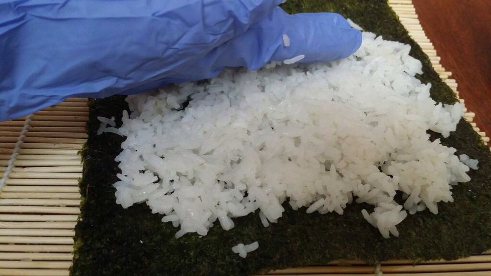Spread the rice with your hands, to cover 2/3 of the seaweed.