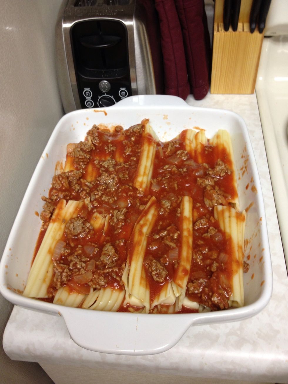 Spread the sauce evenly over the top if the noodles.