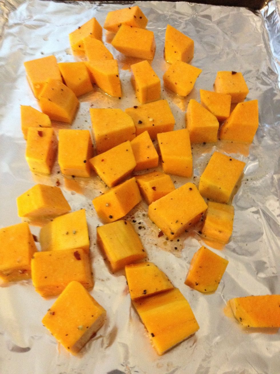 Spread the squash on the cookie sheet.