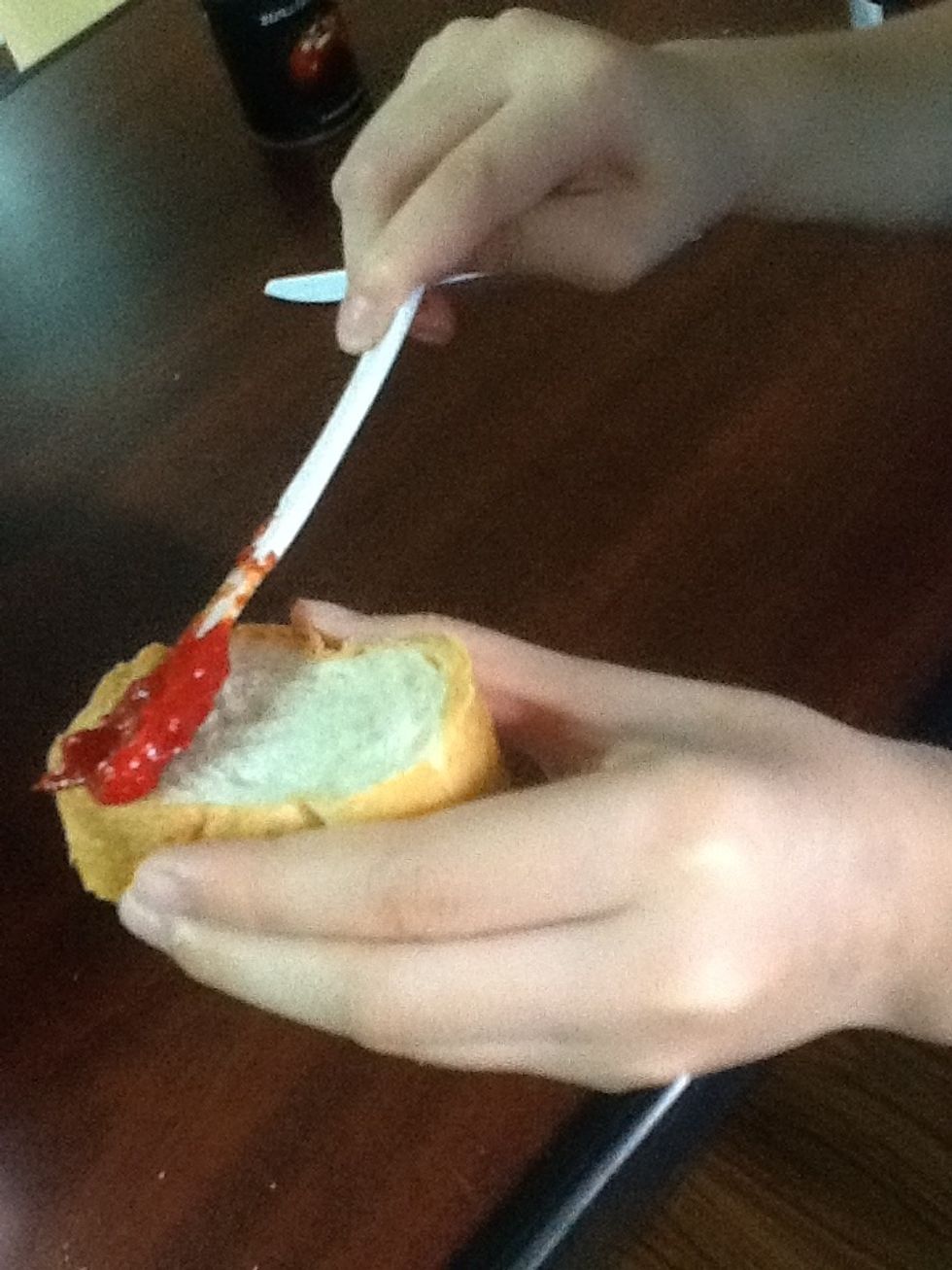 Spread the tomato paste on the bread.
