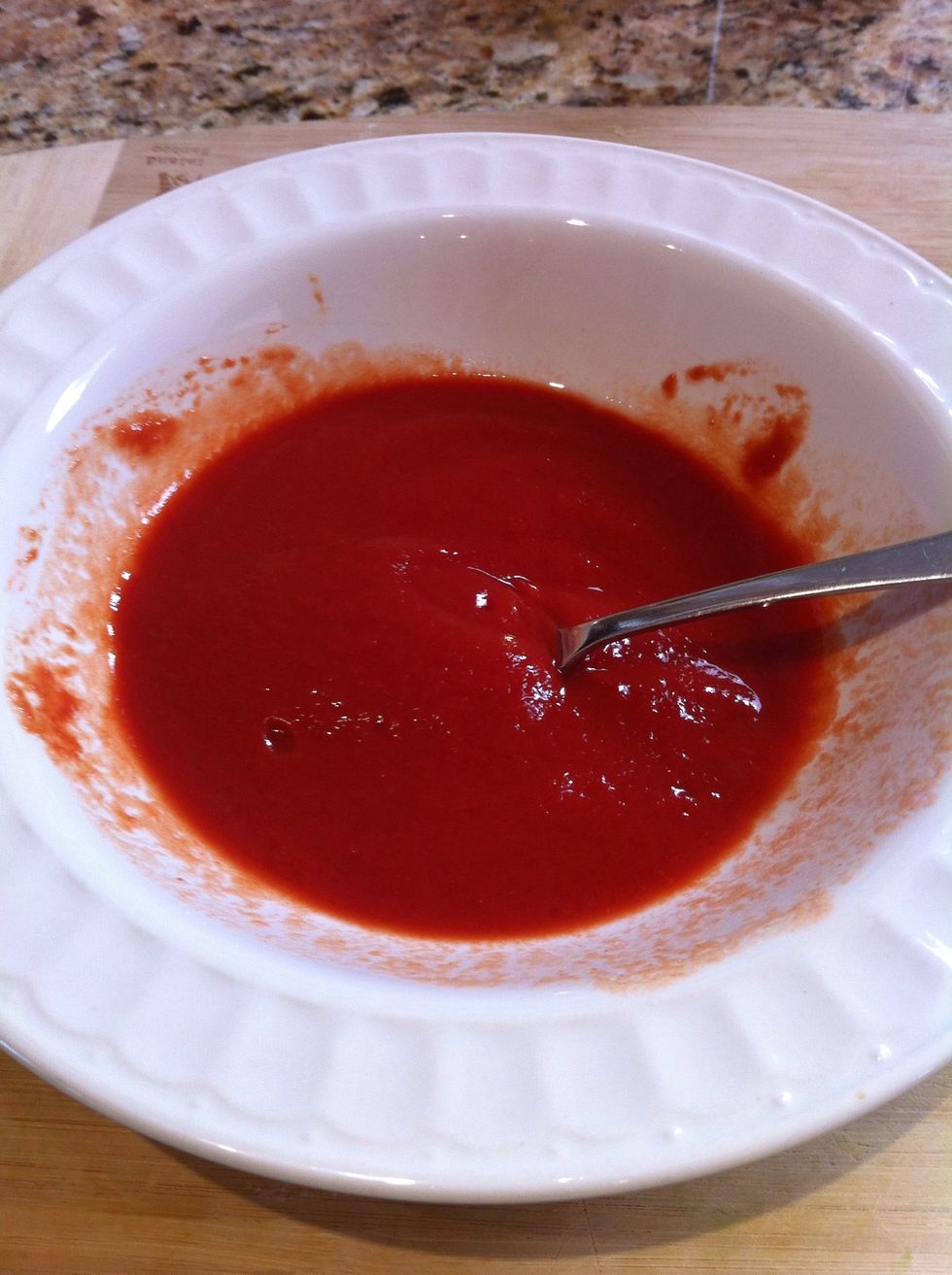 Spread tomato sauce on the dough.