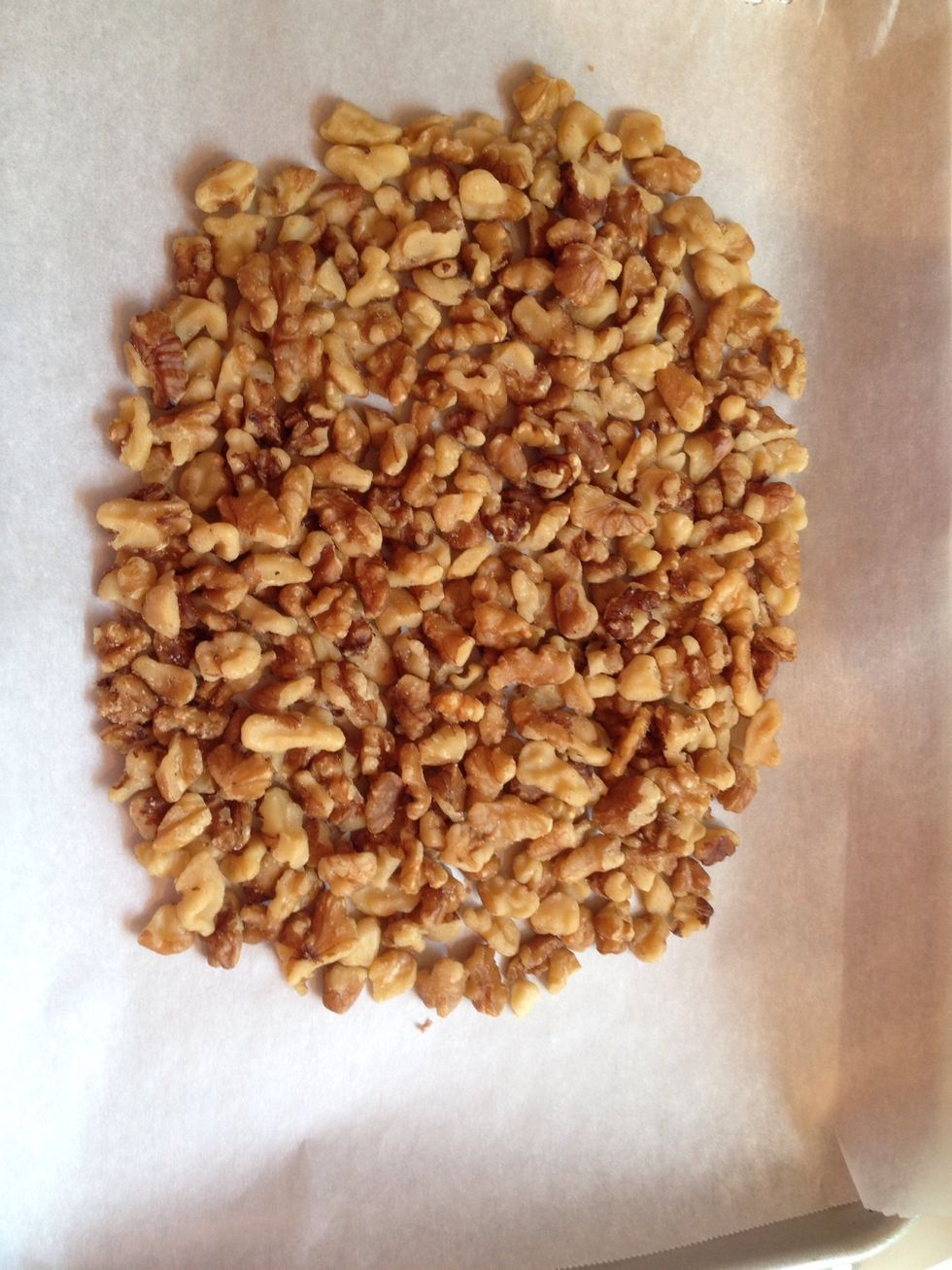 Spread walnuts in a single layer on a baking sheet. Toast in an oven preheated to 350 degrees, until fragrant & lightly browned.