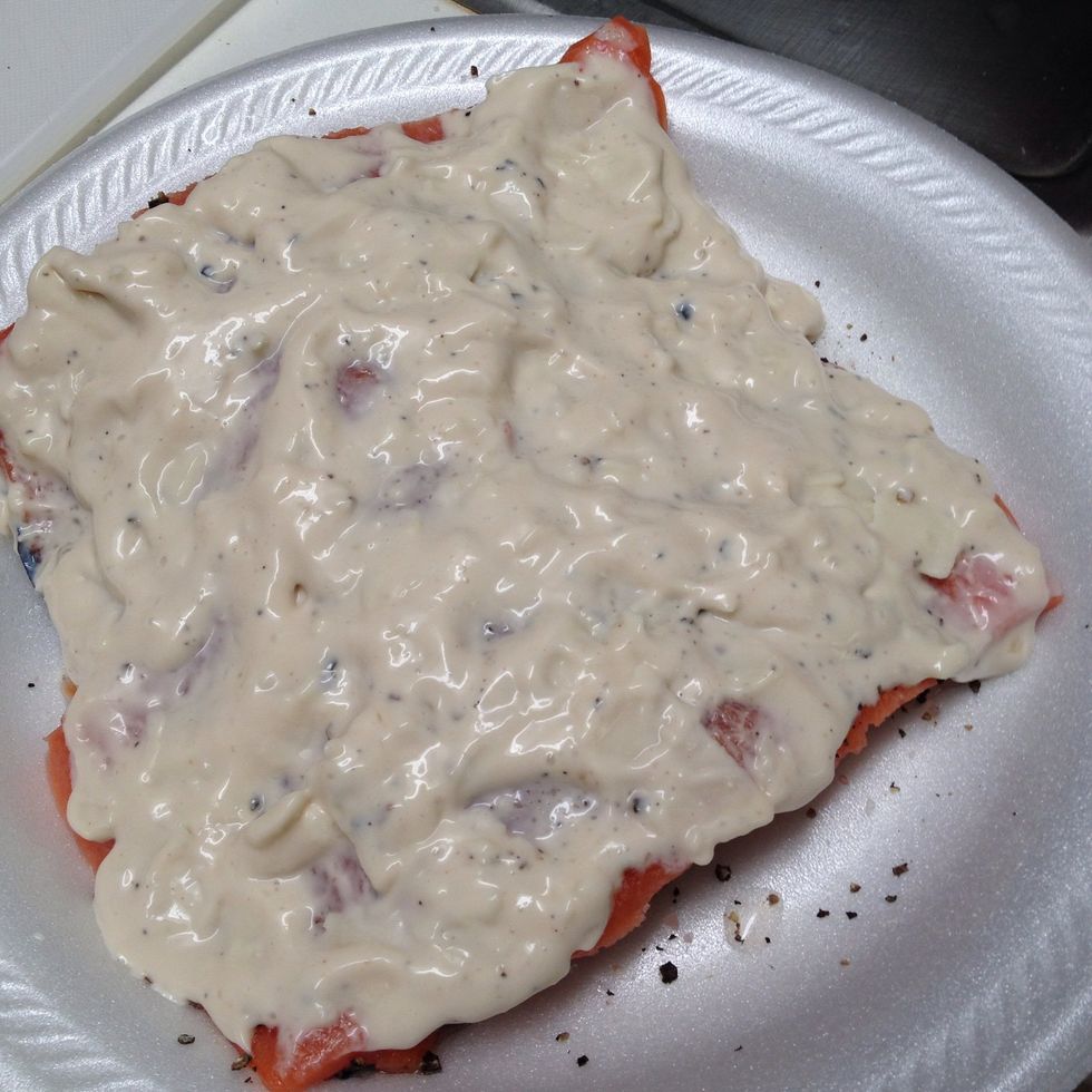 Spread your alfredo mixture evenly on top of the salmon.