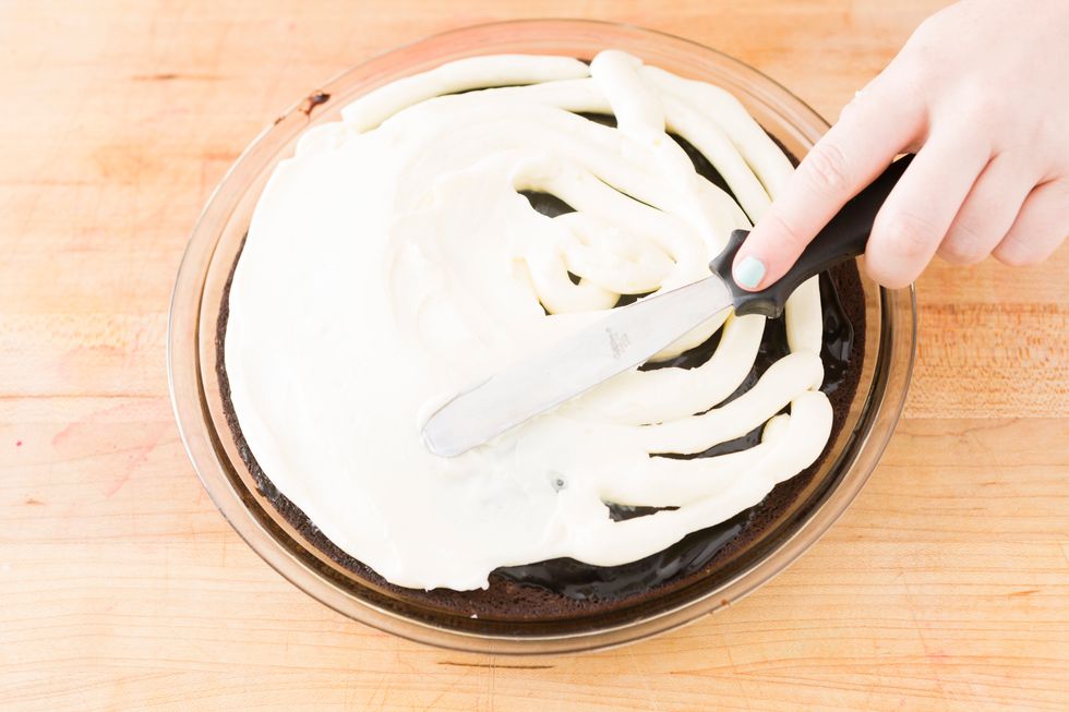 Spread your cream cheese mixture evenly over the top of the cooled brownie pie.