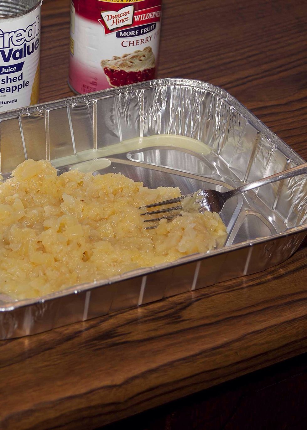 Spread your drained, crushed pineapples into the bottom of your baking dish.  I chose to use a disposable dish since this one was traveling.