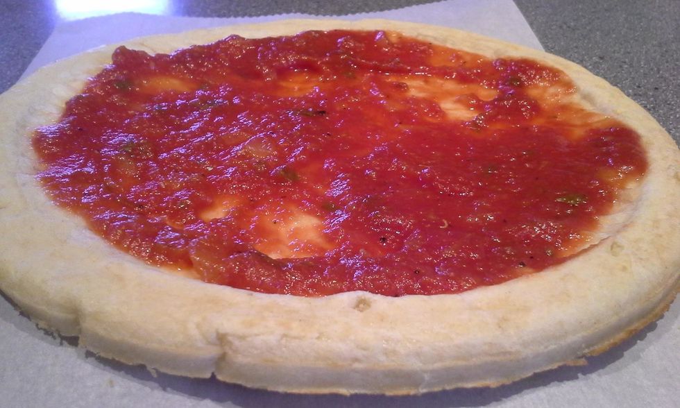 Spread your favorite pizza sauce. My chef husband makes this one from tomatoes, basil, onions and oregano. But you can buy a prepared sauce at the grocery.